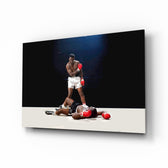 Muhammad Ali glass wall art displayed above a leather chesterfield in a moody man cave with reclaimed-wood console and brass arc lamp