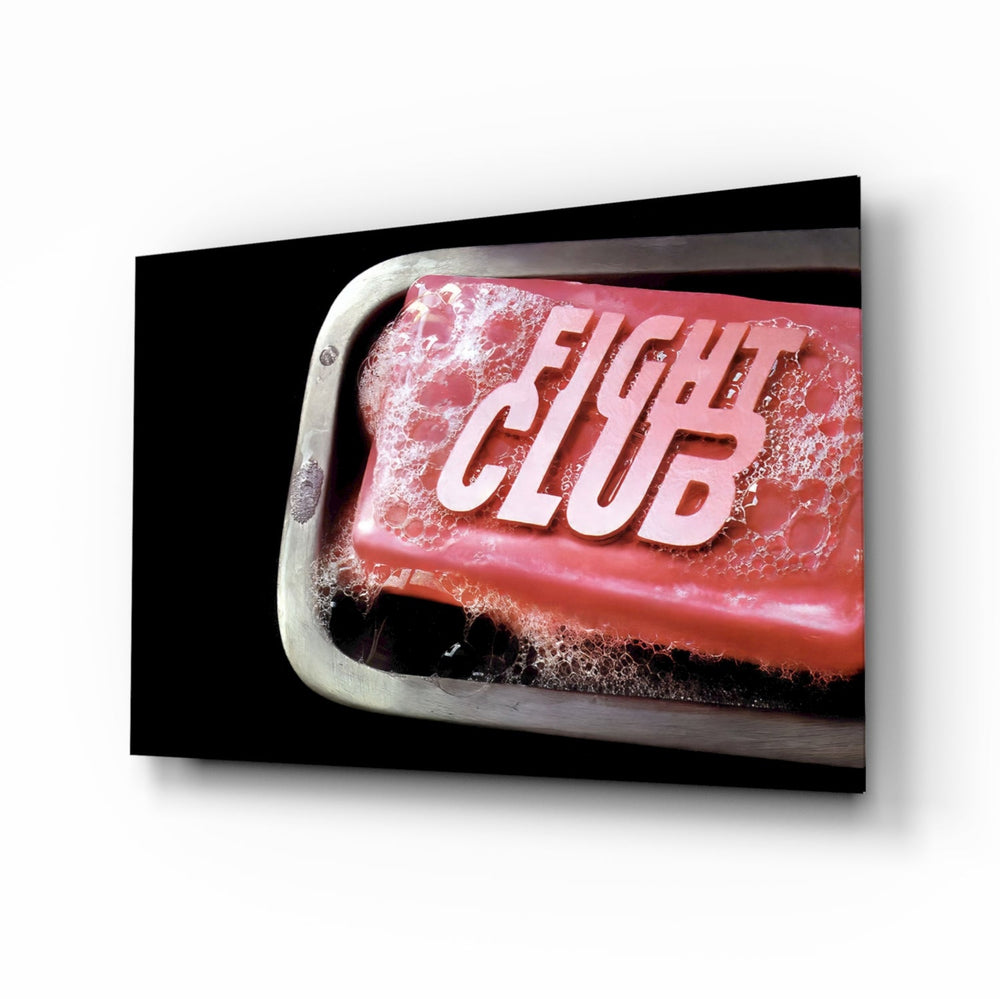 Fight Club glass wall art displayed above a black leather sectional in a moody man cave with brass arc lamp and reclaimed-wood console
