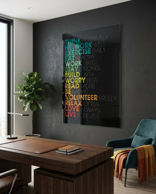 Advices glass wall art displayed above a walnut desk in a contemporary office with rattan armchair and brass picture light