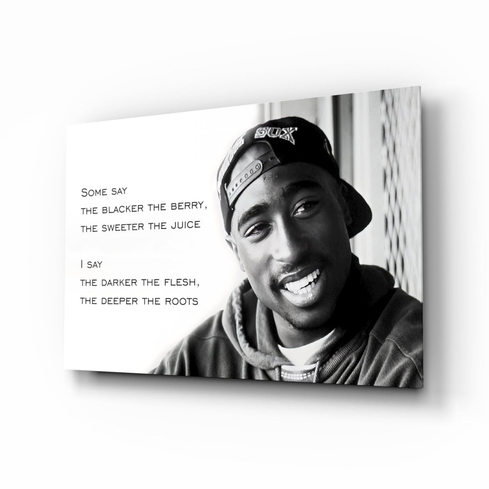 Tupac Shakur glass wall art displayed above a black leather sectional in a moody music room with reclaimed-wood console and brass arc lamp