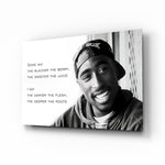 Tupac Shakur glass wall art displayed above a black leather sectional in a moody music room with reclaimed-wood console and brass arc lamp