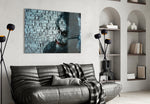 Joker glass wall art styled above a console in a gaming room
