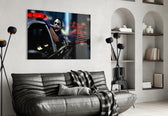 Joker glass wall art styled above a console in a gaming room