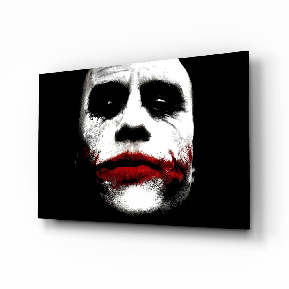 Joker glass wall art displayed above a black leather sectional in a moody home theater with brass arc lamp and reclaimed-wood console