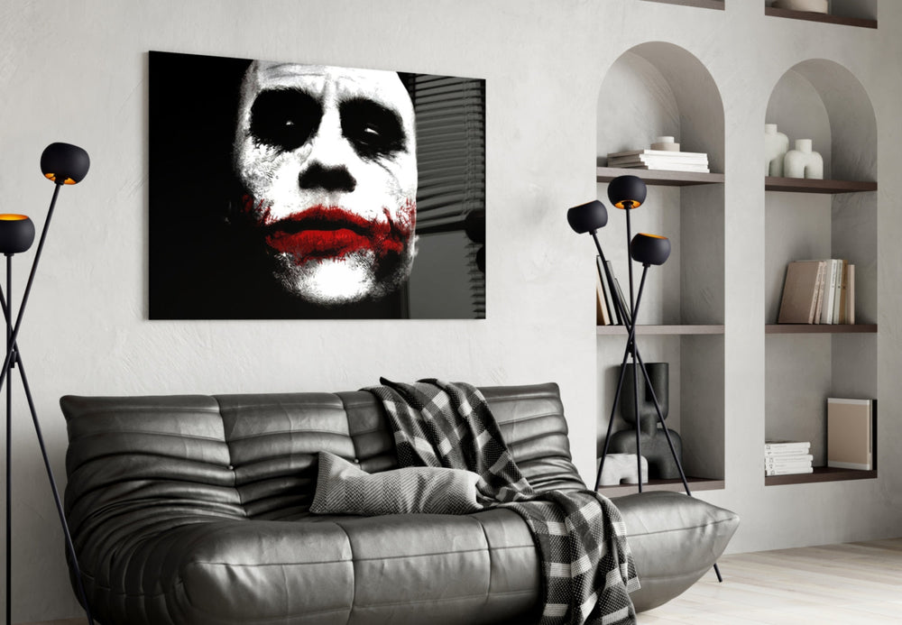 Joker glass wall art styled above a console in a gaming room