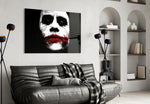 Joker glass wall art styled above a console in a gaming room