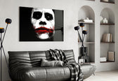 Joker glass wall art styled above a console in a gaming room