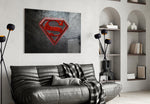 Superman glass wall art styled above a console in a gaming room