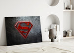Superman close-up showing crimson shield on brushed-steel field with scratches