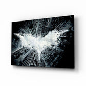 Batman and Gotham City glass wall art displayed above a black leather sectional in a moody home theater with brass arc lamp and reclaimed-wood console