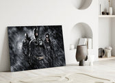 Batman, Catwomen and Bane close-up showing trio in monochrome Gotham rain