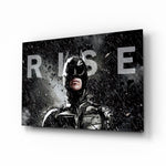 Batman Rise glass wall art displayed above a black leather sectional in a moody home theater with brass arc lamp and reclaimed-wood console
