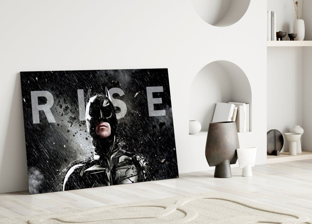 Batman Rise close-up showing Dark Knight cowl with monumental RISE wordmark in sleet