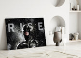 Batman Rise close-up showing Dark Knight cowl with monumental RISE wordmark in sleet