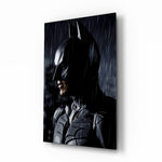 Batman glass wall art displayed above a black leather sectional in a moody home theater with brass arc lamp and reclaimed-wood console