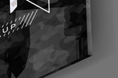 Close-up detail of the blue and silver camo typography behind glass