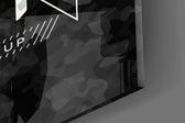 Close-up detail of the gold and silver camo typography behind glass