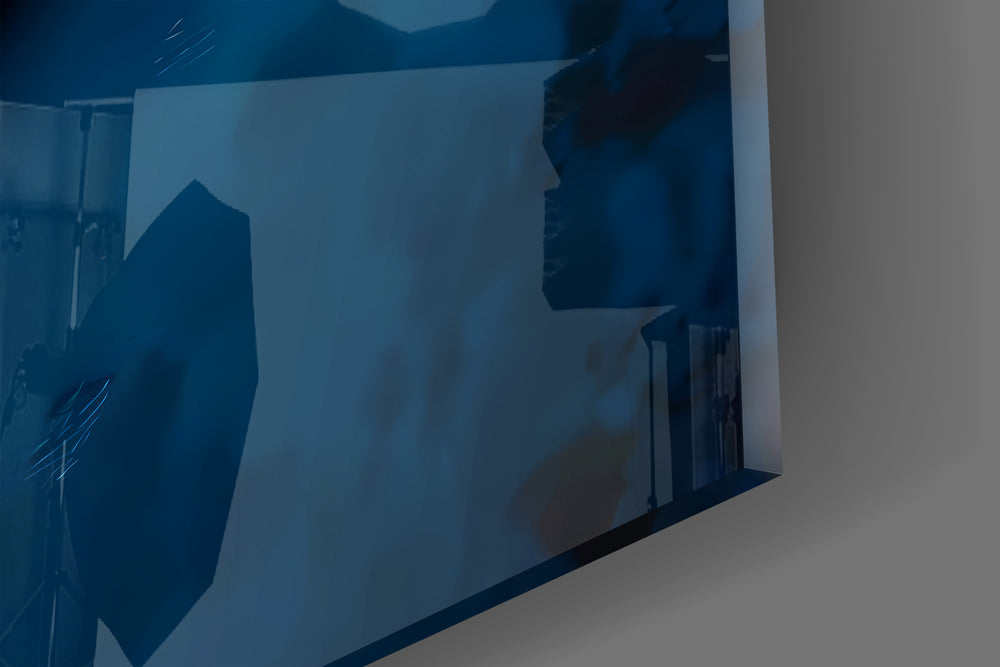 Close-up detail of the red and yellow S on cobalt surface behind glass