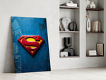 Superman shield artwork above a gaming setup with ambient light