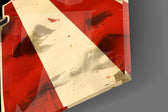 Close-up detail of the chrome microphone on red and cream rays behind glass