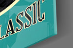 Close-up detail of the worn black vinyl on teal background behind glass
