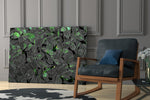 Moody botanical artwork in a creative office with low light