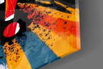 Close-up detail of the splattered scarlet and marigold typography behind glass