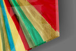 Close-up detail of the brushed rainbow rays and cream center behind glass