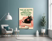French cat-poster artwork styled in an entryway with warm palette