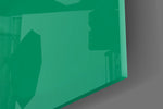 Close-up detail of the alien and white cardboard sign behind glass