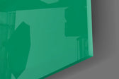 Close-up detail of the alien and white cardboard sign behind glass