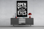 Open Your Eyes glass wall art catching light to reveal its inked texture
