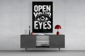 Open Your Eyes glass wall art catching light to reveal its inked texture