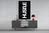 Hustle glass wall art catching light to reveal its high-contrast typography