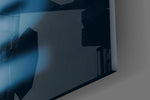 Close-up detail of the sharp ivory and blurred blue typography behind glass