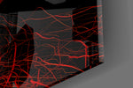 Close-up detail of the tangled scarlet threads behind glass