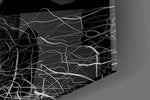 Close-up detail of the tangled white threads behind glass