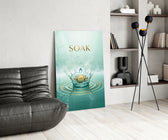 soak golden lotus water crown glass wall art leaning beside a dark leather sofa