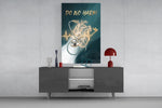 do no harm stethoscope and golden heart glass wall art displayed above a console in a designer interior