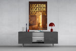 gold real estate key with a skyline glass wall art displayed above a console in a designer interior