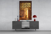 gold real estate key with a skyline glass wall art displayed above a console in a designer interior