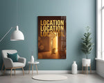 gold real estate key with a skyline glass wall art styled above an armchair in a reading corner