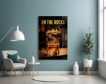 whiskey glass with a golden skyline glass wall art styled above an armchair in a reading corner