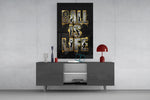 gold Ball Is Life basketball typography glass wall art displayed above a console in a designer interior