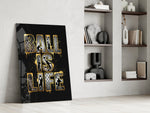 gold Ball Is Life basketball typography panel resting in a shelving niche in a modern interior