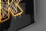 Close-up detail of the mesh-filled gold letters and dribbling silhouette on the glass surface