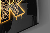 Close-up detail of the mesh-filled gold letters and dribbling silhouette on the glass surface