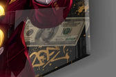Close-up detail of the golden dollar sign and crimson suit on the glass surface