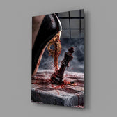 stiletto heel crushing a chess king glass wall art angled to show the polished tempered glass panel