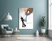 low-poly hand toppling a chess king glass wall art styled above an armchair in a reading corner